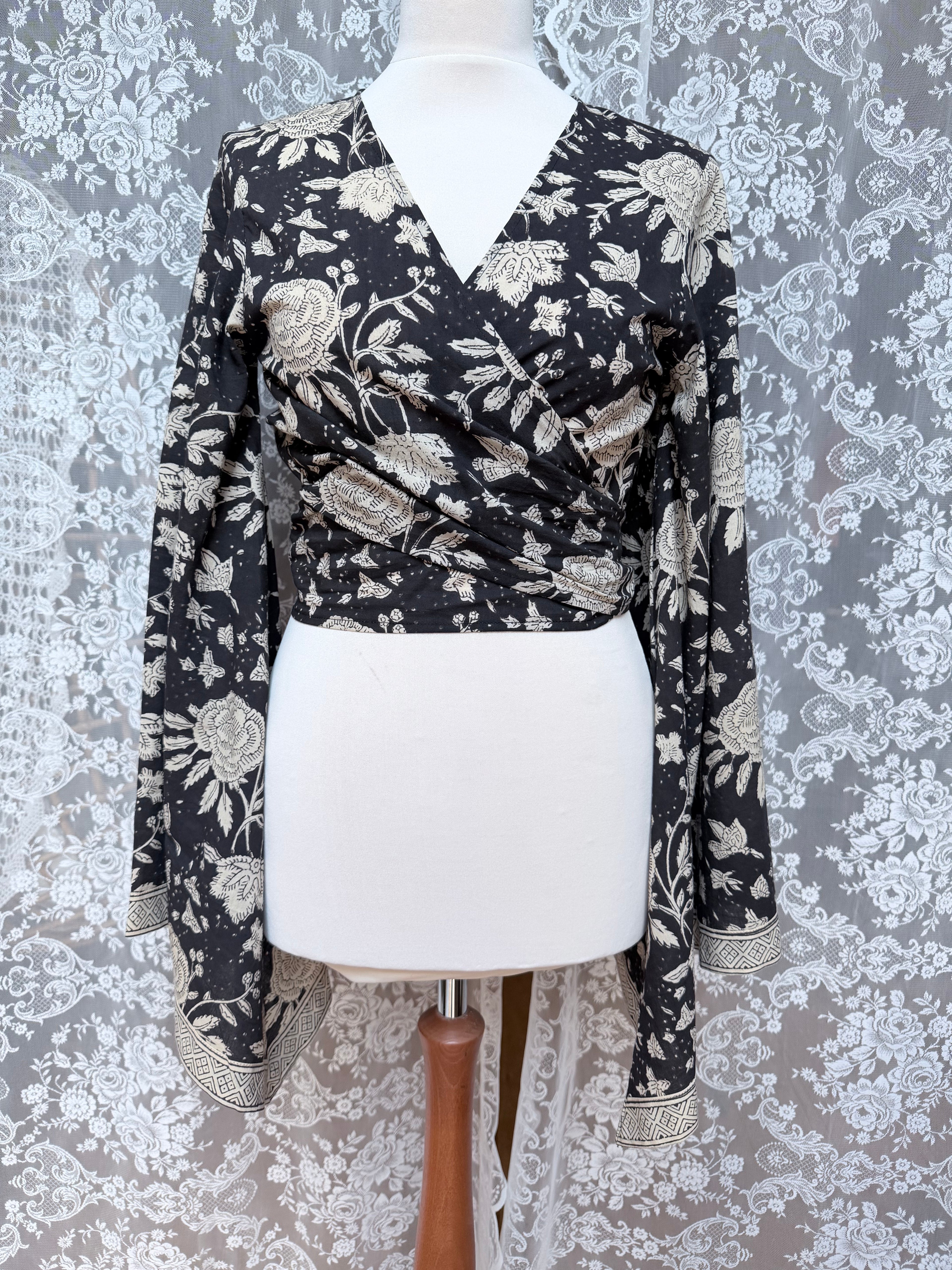 The Sofiya: Bell Sleeve Block Print Wrap Blouse in Black Floral