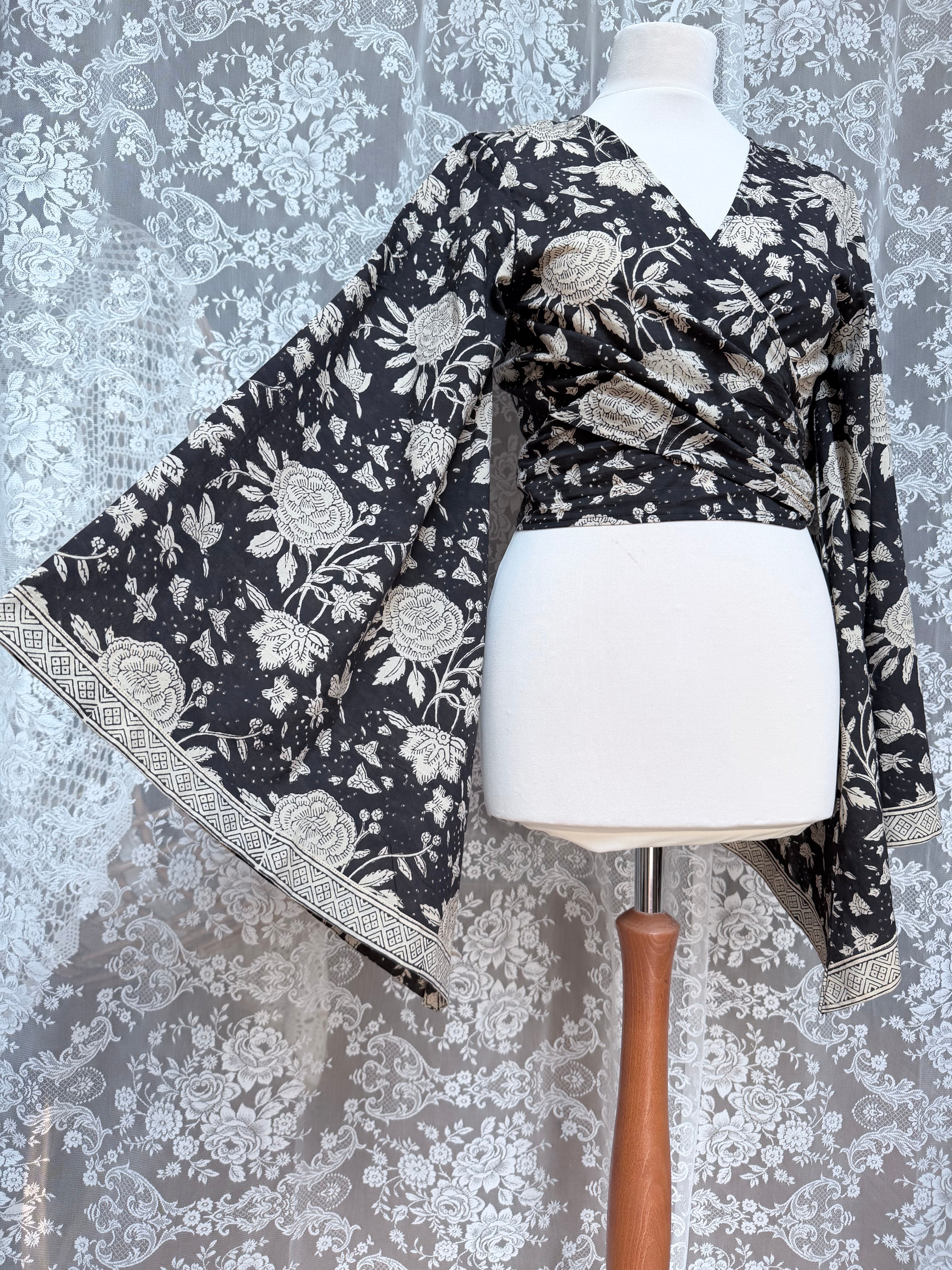The Sofiya: Bell Sleeve Block Print Wrap Blouse in Black Floral