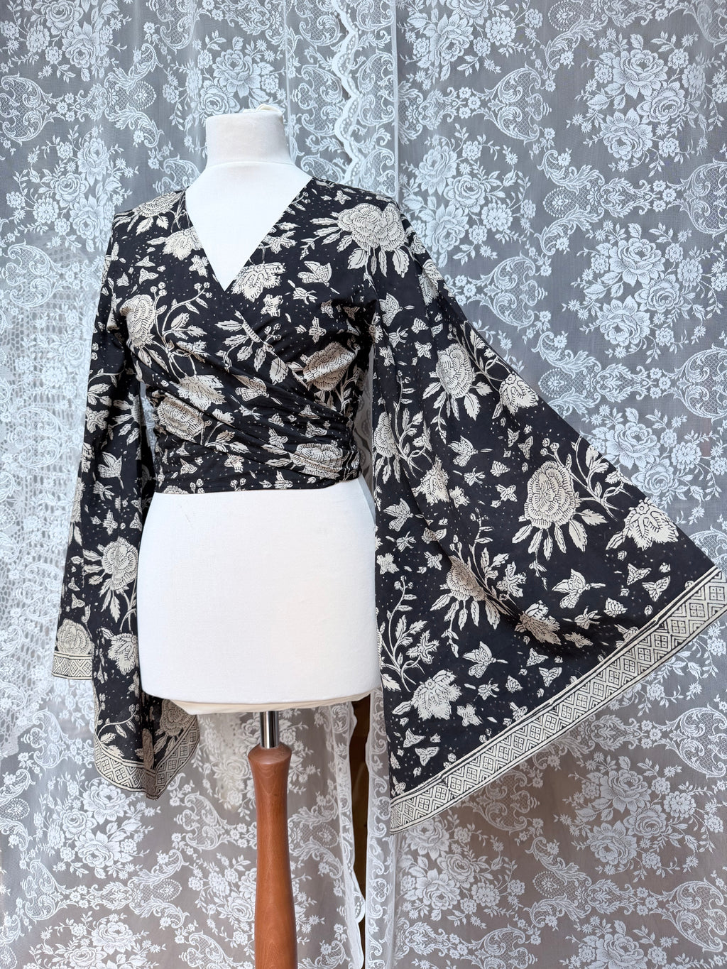 The Sofiya: Bell Sleeve Block Print Wrap Blouse in Black Floral