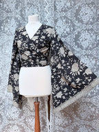 The Sofiya: Bell Sleeve Block Print Wrap Blouse in Black Floral