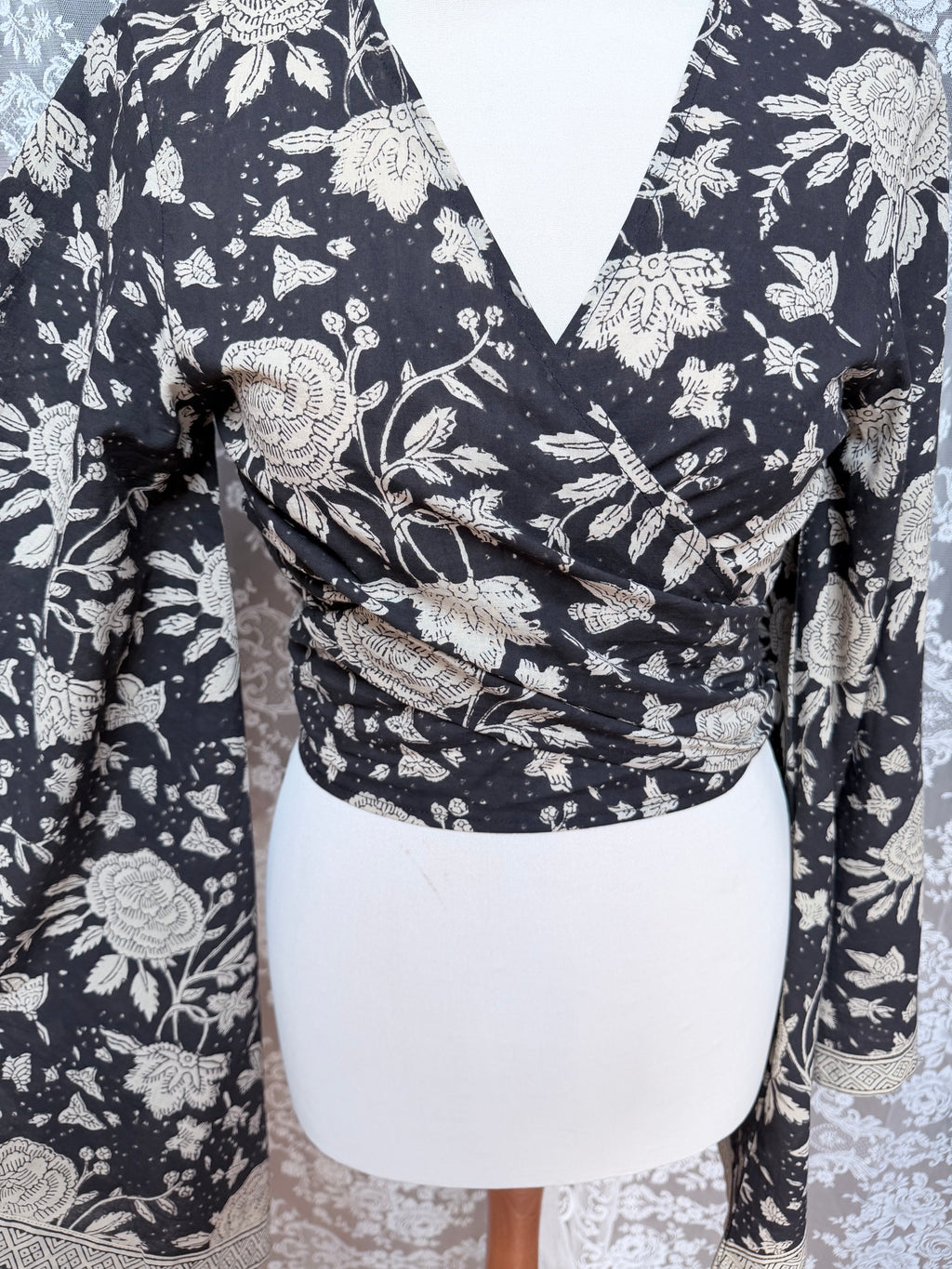 The Sofiya: Bell Sleeve Block Print Wrap Blouse in Black Floral