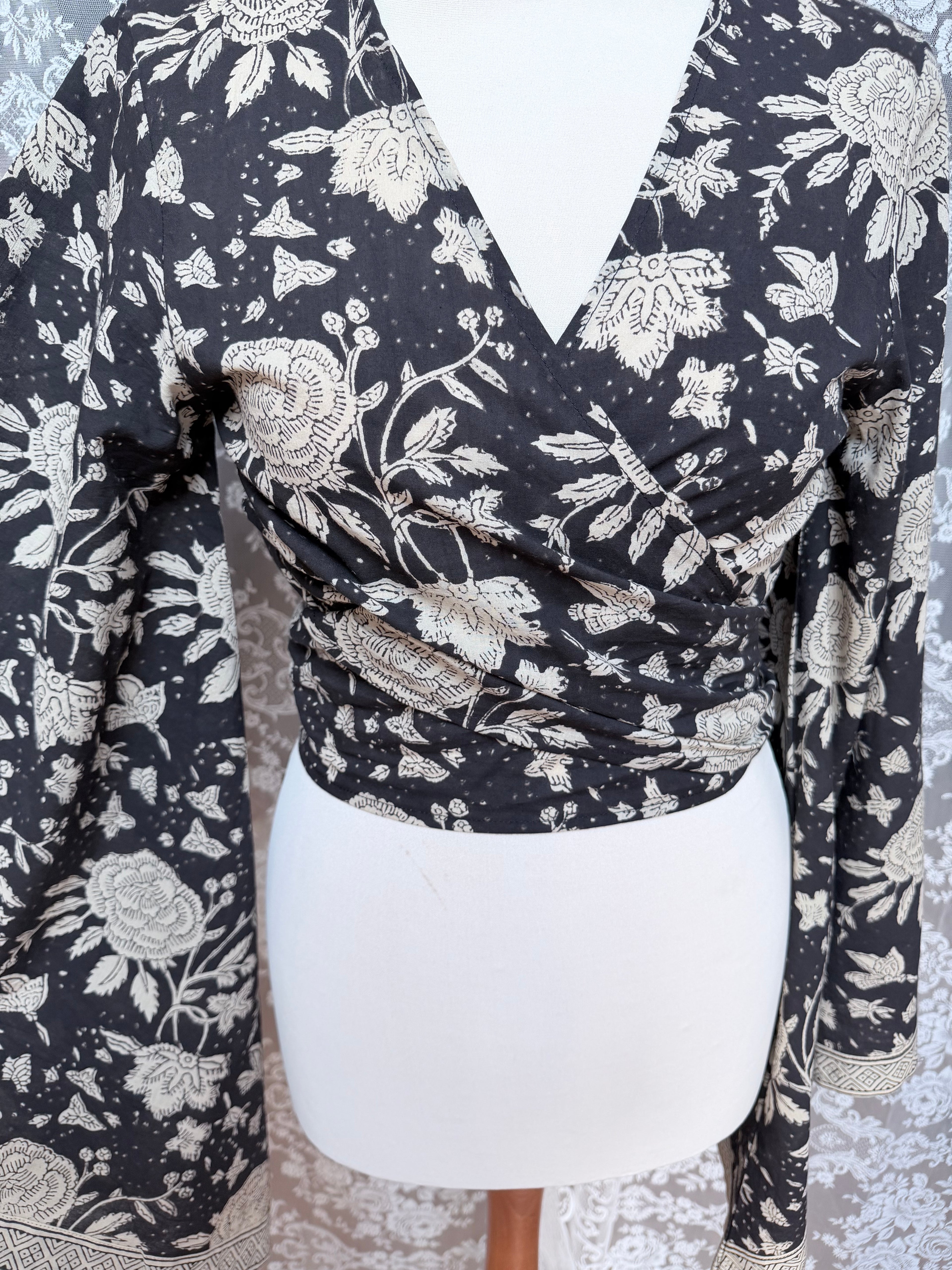 The Sofiya: Bell Sleeve Block Print Wrap Blouse in Black Floral