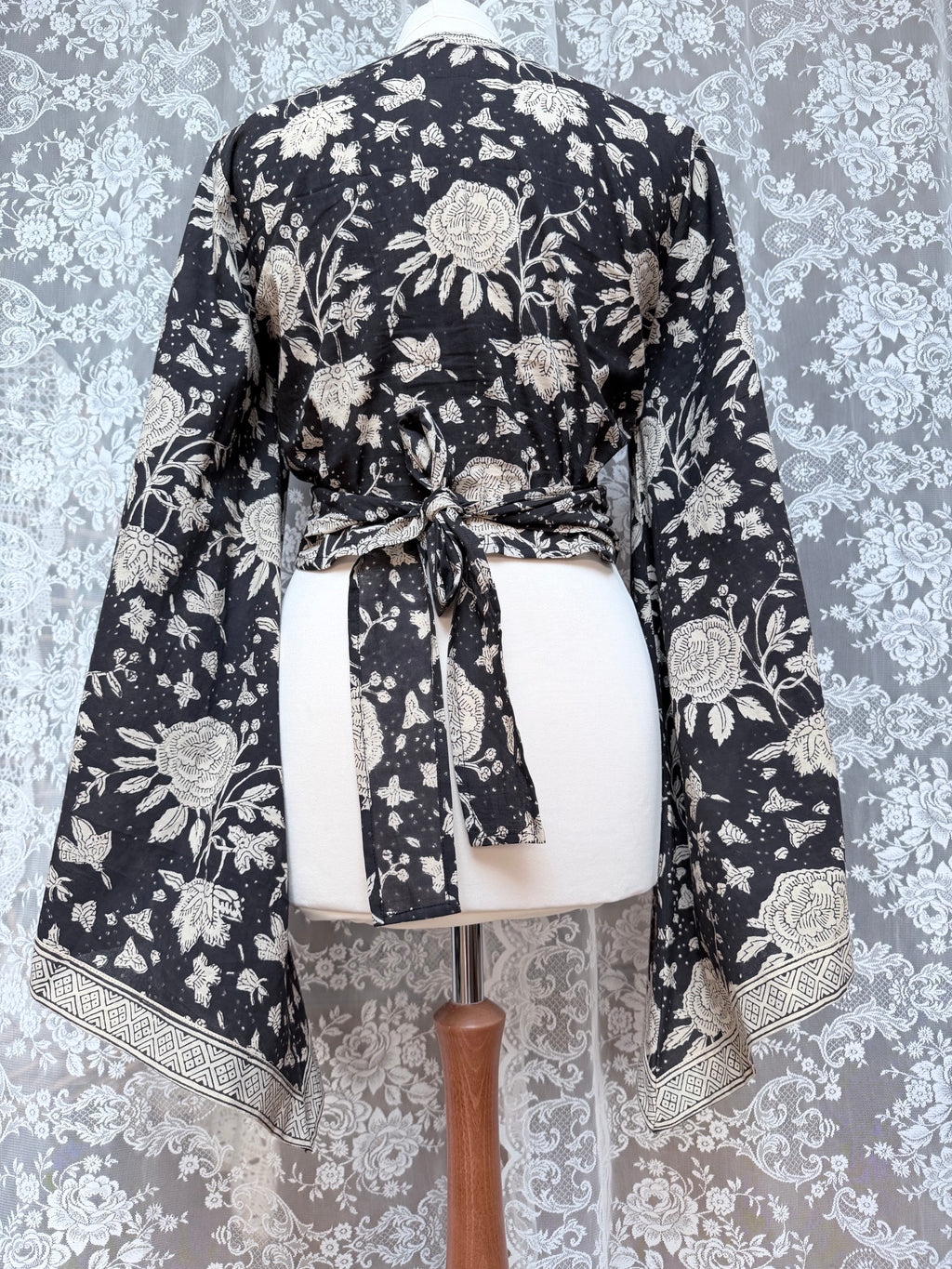 The Sofiya: Bell Sleeve Block Print Wrap Blouse in Black Floral