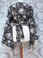 The Sofiya: Bell Sleeve Block Print Wrap Blouse in Black Floral