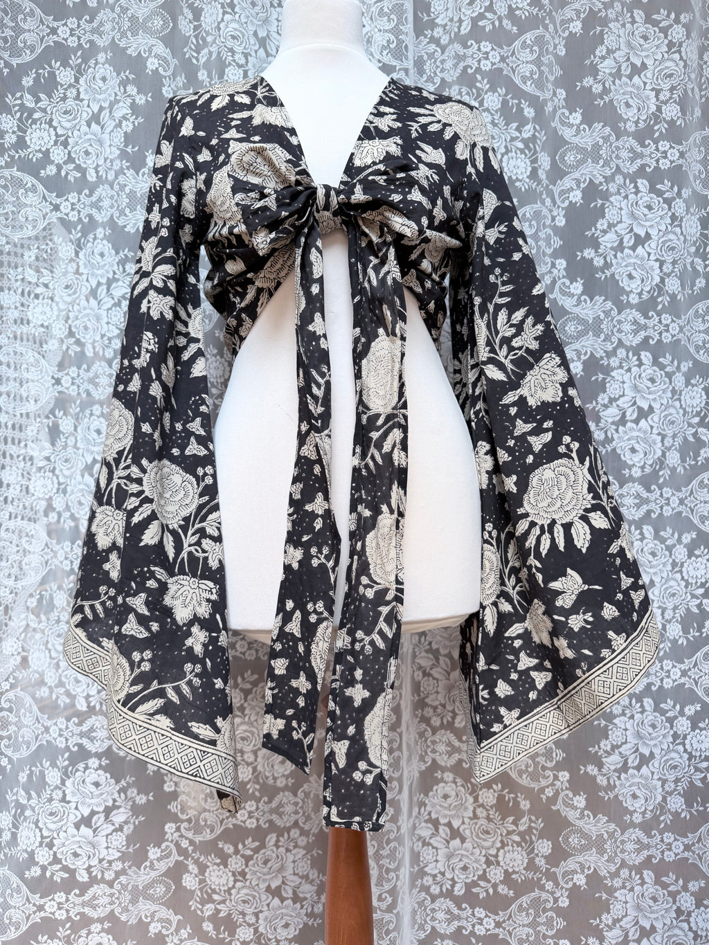 The Sofiya: Bell Sleeve Block Print Wrap Blouse in Black Floral