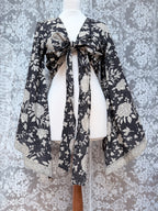 The Sofiya: Bell Sleeve Block Print Wrap Blouse in Black Floral