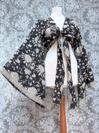 The Sofiya: Bell Sleeve Block Print Wrap Blouse in Black Floral