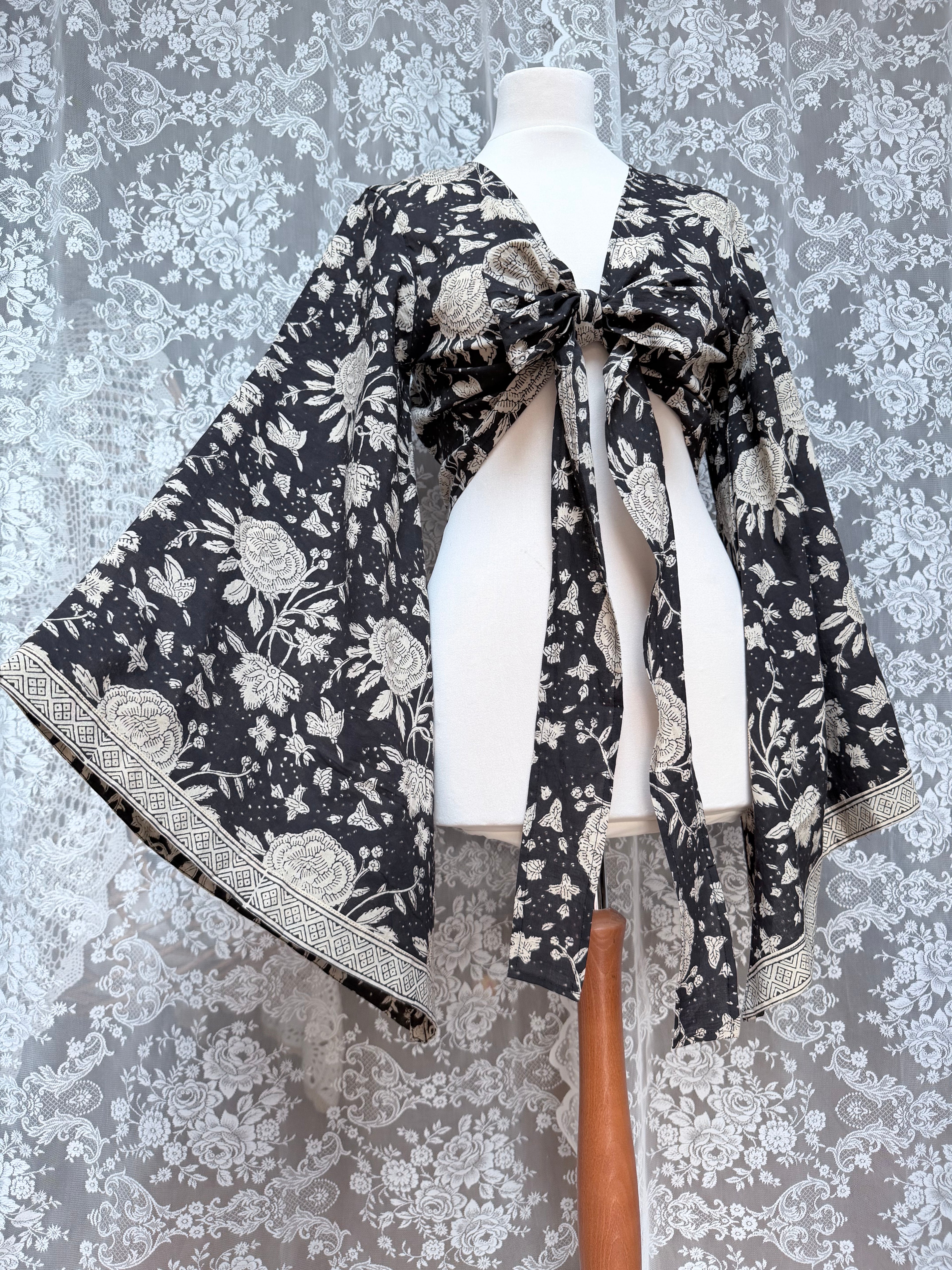 The Sofiya: Bell Sleeve Block Print Wrap Blouse in Black Floral